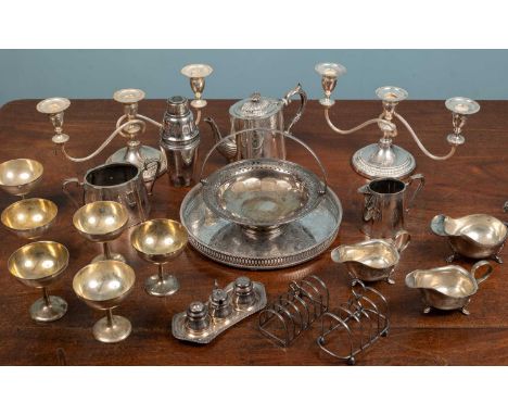 A collection of silver plate to include a three piece tea set, a cocktail shaker, a pair of candelabra etcItems with minor ma