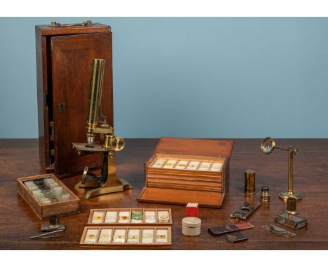 A collection of scientific instruments and other items, comprising of a microsope, two wooden boxes of microscope slides and 