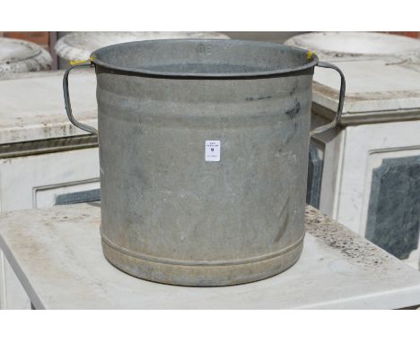 A galvanised twin handled planter.
