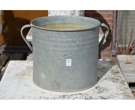 A galvanised twin handled planter.