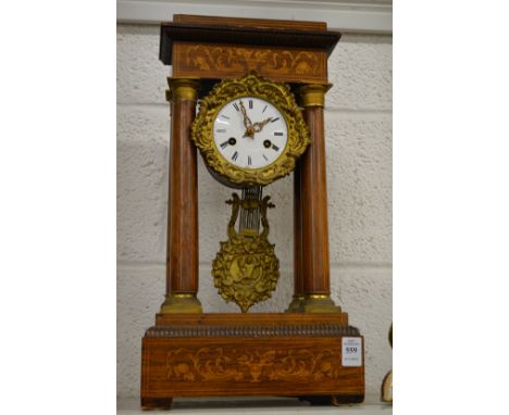 An inlaid rosewood portico mantel clock.