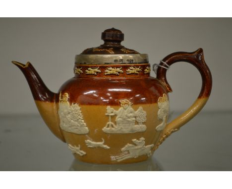 A miniature Doulton salt glazed teapot with silver rim.