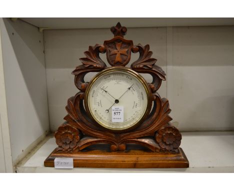 A Victorian carved walnut framed desk barometer.