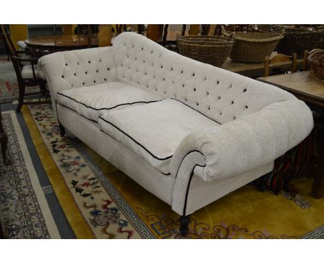 A good button upholstered shaped back large two seater settee.