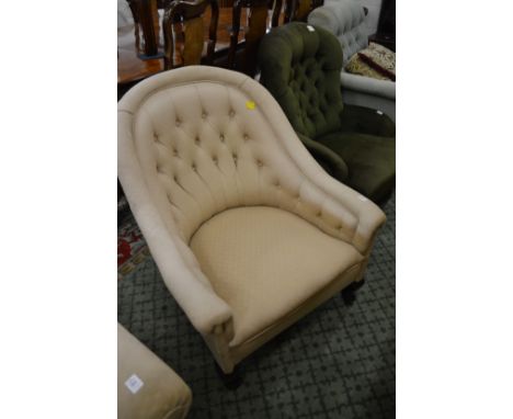 A button upholstered horseshoe shaped armchair.