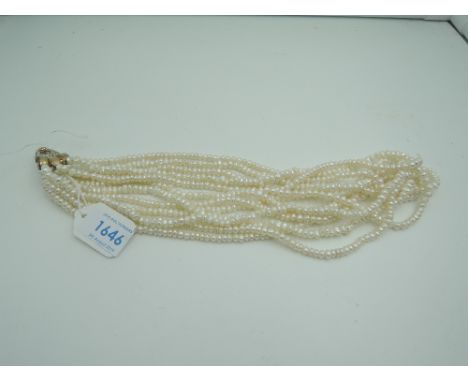 A six string baroque pearl necklace having gold plated clasp stamped 800