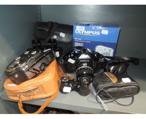 A selection of optical devices including Nikkormat camera and Quarz film recorder