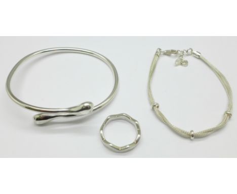 A silver bangle, bracelet and ring 
