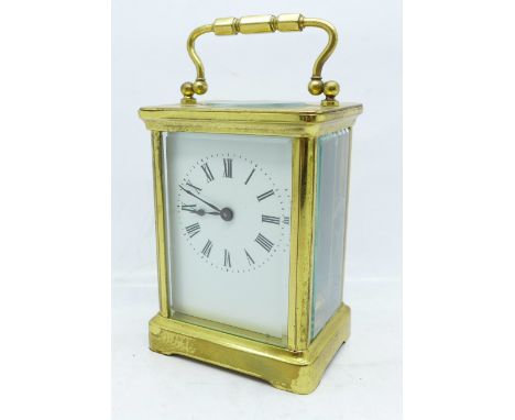 A brass and four glass sided carriage clock with key, back glass panel a/f 