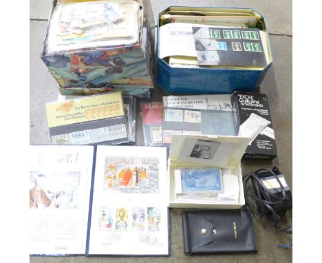 A collection of loose stamps, presentation covers, ultra violet light, guillotine, etc. 