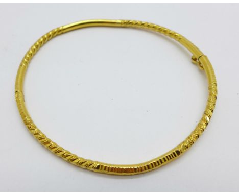 A yellow metal bangle marked 916, (22ct), 13.1g 