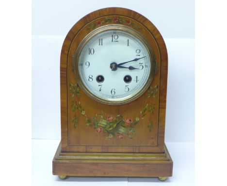 A walnut arch top striking mantel clock with transfer printed decorative case 
