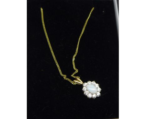 A 9ct gold, opal and cubic zirconia pendant on a 9ct gold chain 