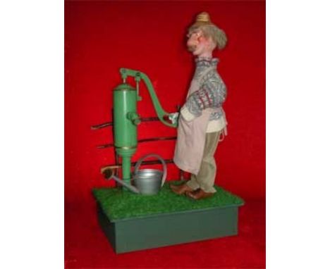 The Gardener Wooden automaton, biscuit and fabric. Unique. Standing operating a pump that water fills in a watering can. Elec