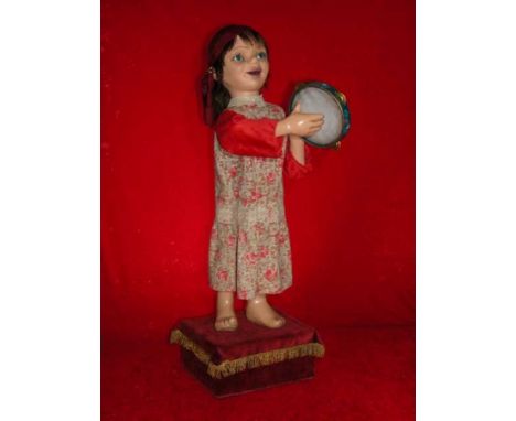 The Bohemian Wooden automaton, fabric, metal and skin, standing and striking a tambourine. Electrified window display automat
