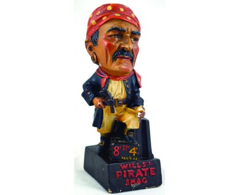 WILLS S PIRATE SHAG BAR BACK/ SHOP FIGURE. 14.5ins tall, pirate figure, pipe in hand one foot stood on chest atop plinth WILL