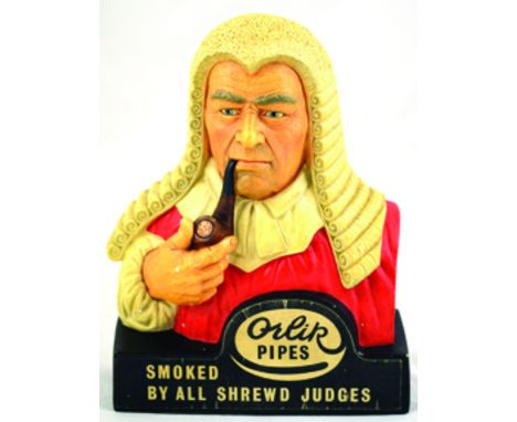 ORLIK PIPES ADVERTISING BUST. 10ins tall, formed as judge smoking pipe in white, red & brown ORLIK PIPES/ SMOKED/ BY ALL SHRE