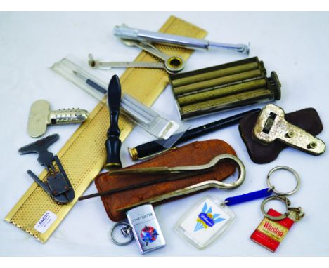 MIXED GROUP. Pipe tampers, pipe cleaning tools, cigarette roller, key rings etc. (14) NR