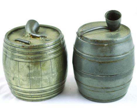 PAIR OF PEWTER TOBACCO JARS. Both barrel shape with pipe shaped finials attached to lid tops, one with inside tamper, tallest