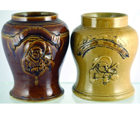 PAIR OF SHOP DISPLAY JARS. Both 8ins tall, shiny brown & mustard glaze raised gent smoking pipe with scroll above. (2) Good. 