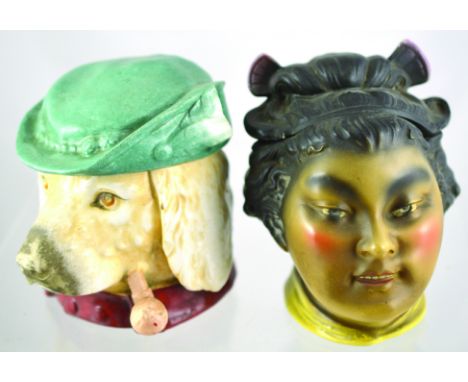 PAIR OF TOBACCO JARS. Continental dogs head smoking pipe, green hat lid. Plus Japanese Geisha girl (?) jar, in brown, black, 