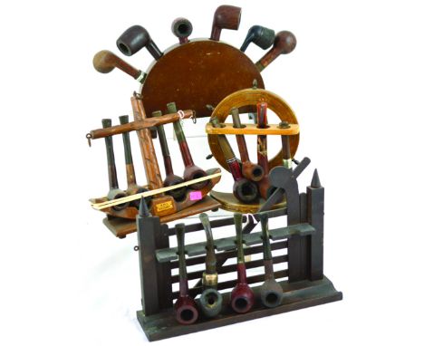 GROUP OF PIPE RACKS & STANDS. All wood ships wheel & farmers gate, semi circular anchor H.M.S. Victory. All with pipes. (4) N
