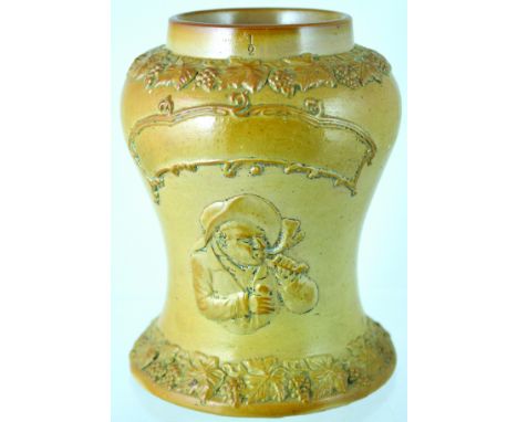 SHOP DISPLAY TOBACCO JAR. 8.5ins tall, tan salt glaze, waisted shape jar, raised pipe smoker with scroll above & grapes & vin