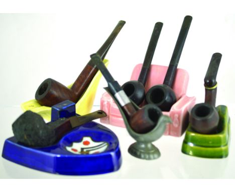 GROUP OF PIPE RESTS. Ceramic sofa, 2 other ceramic rests, metal pipe rest in shape of bird & shield shape ashtray/ pipe rest.