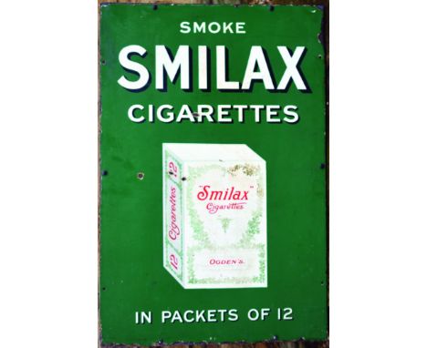 SMILAX CIGARETTES ENAMEL SIGN. On wooden back 36 by 24ins, SMOKE/ SMILAX/ CIGARETTES/ IN PACKETS OF 12 with cigarette packet 
