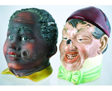 PAIR OF TOBACCO JARS. Josef Stranet Jun jar, red hat/ fez cover, mans head with beetle on his nose. Base hairline German c. 1