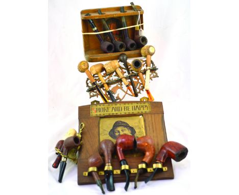 GROUP OF PIPE RACKS & STANDS. 2 wooden racks one with SMOKE AND BE HAPPY plus brass racks. All with pipes. (4) NR