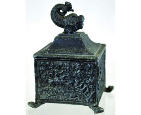 LEAD TOBACCO JAR. 6.75ins tall to top of cover with dolphin finial. Square shape stood on four feet with hunting scenes to fo