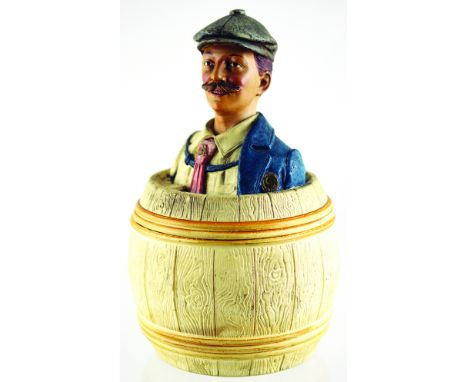 AUSTRIAN TOBACCO JAR. 8.75ins tall, lid formed with flat capped gent with blue coat & red tie atop barrel base. C. 1850 J Mar