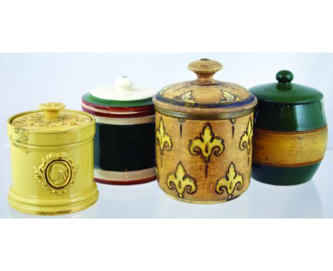 GROUP OF TOBACCO JARS. Matt brown glaze jar & cover with fleur de lis design plus cream glazed jar & cover with raised cameos