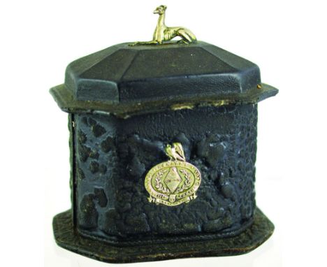 LEATHER TOBACCO JAR. 6.5ins tall to top of silver plated greyhound finial, casket shape with tamper, silver plaque to front H