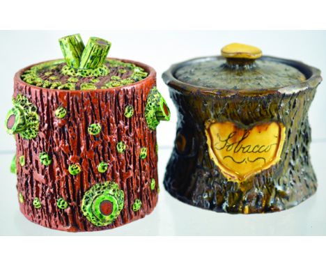 PAIR OF EARTHENWARE TOBACCO JARS. Rustic tree trunk style jars, one brown glaze with green cut off branches etc. Cover with T