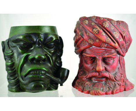 PAIR OF TOBACCO JARS. One large green glazed head of angry looking man smoking pipe, c. 1900 (no lid) & large red terracotta 