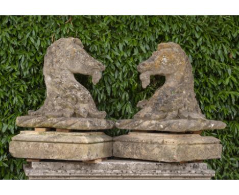Architectural: A pair of rare Bath stone armorial gate pier capitals in the form of horses heads,    18th century, on plinths