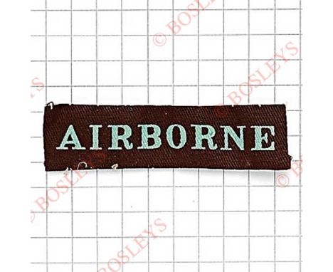 AIRBORNE WW2 straight shoulder title / strip.Light blue printed on maroon.Vendor stated removed from nurse’s cape