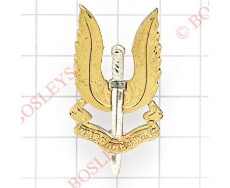 Special Air Service Officer’s SAS cap badge.Die-cast silvered dagger, the wings and “Who Dares Wins” scroll in gilt.Designed 