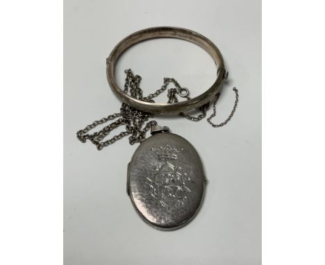 .800 silver locket together with a sterling silver bangle.