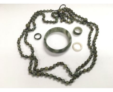 A collection of jade jewellery items.