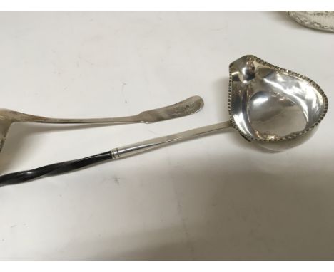 A 19th century white metal toddy ladle with a whale bone handle and a George III Scottish silver sauce ladle. (2)