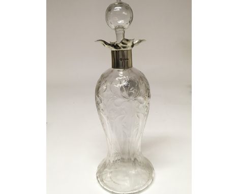 A William Hutton and Sons cut glass silver mounted decanter with Sheffield hallmarks.