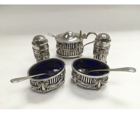 An ESB silver cruet set comprising salt and pepper, mustard pot and two salts with spoons (one spoon not ESB).