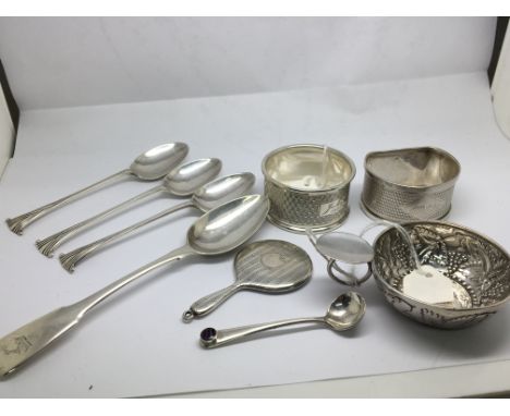 A collection of silver comprising napkin rings a miniature hand mirror spoons including a spoon made by Peter and William Bat