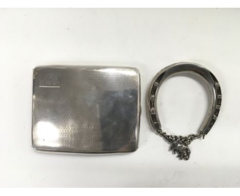 A silver cigarette case and an unmarked silver bangle (2).