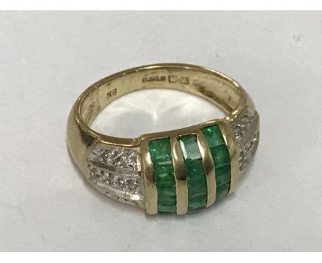 An emerald and diamond set ring. Ring size K