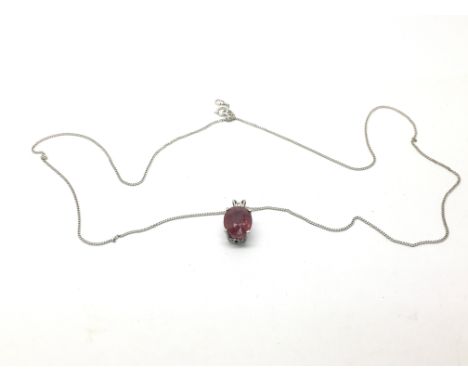 An 18ct white gold and ruby pendant on an 18ct gold chain, approx 2.7g.