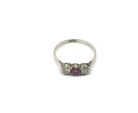 A platinum ring set a central ruby and two diamonds, approx size N and approx 2.2g.